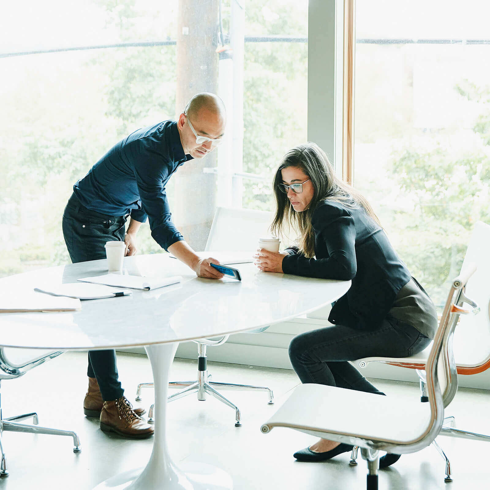 Two people collaborating at a modern office table